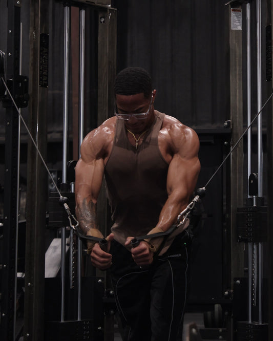 man doing standing chest press with cable machine